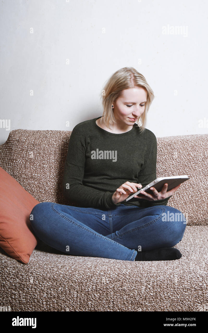 young woman relaxing on couch with tablet computer Stock Photo - Alamy
