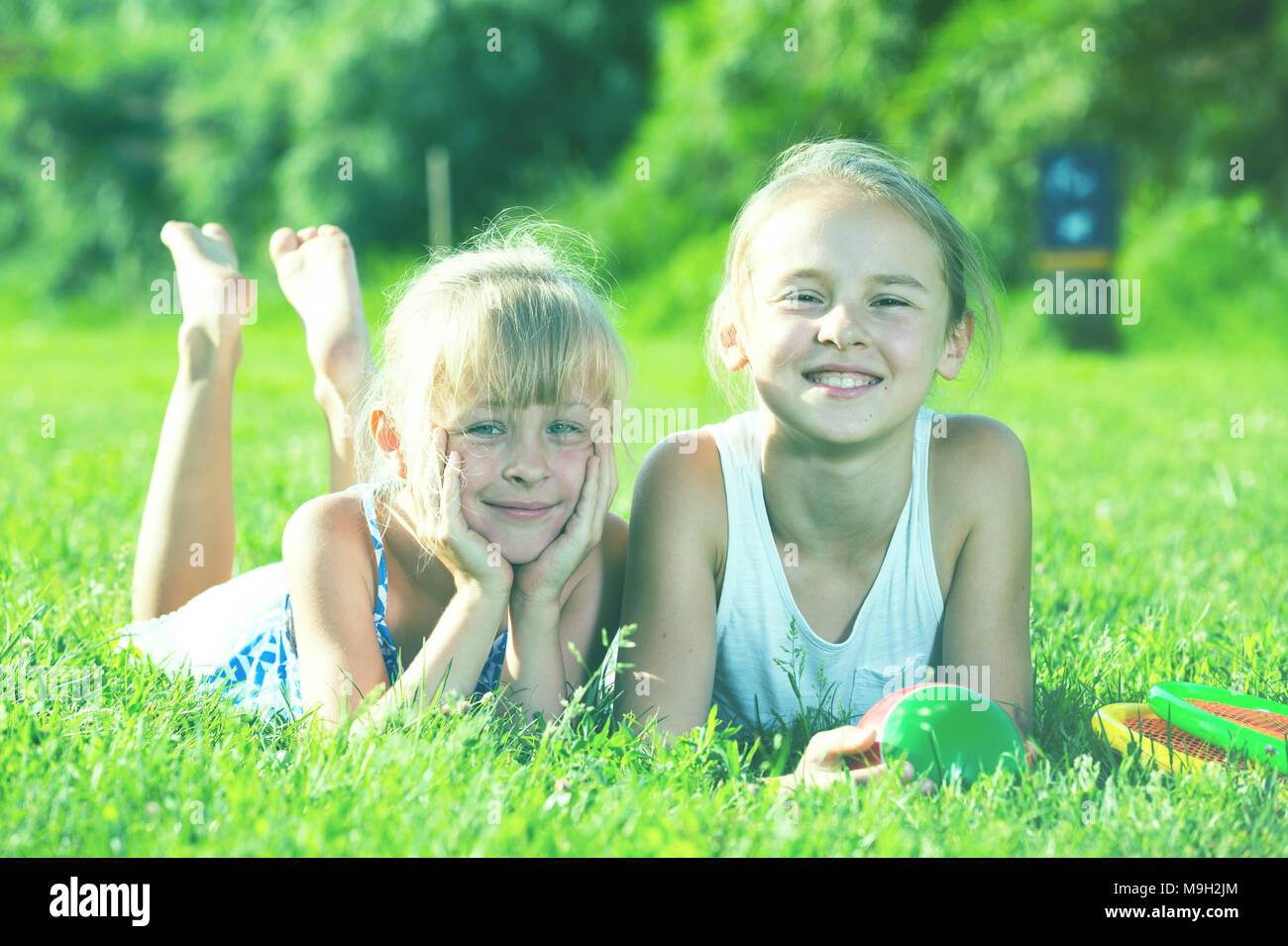 Little friends laying on grass hi-res stock photography and images - Alamy