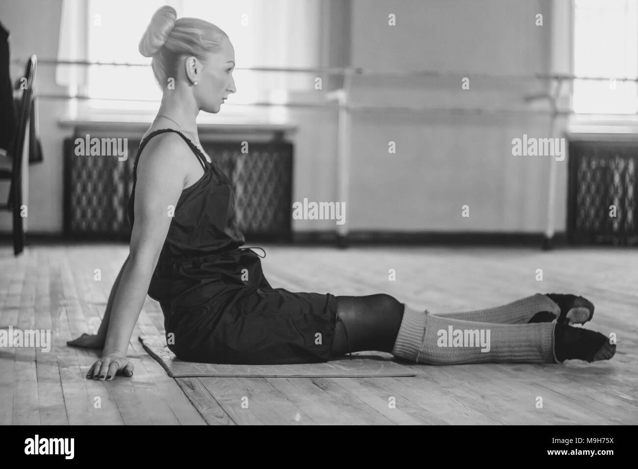 the dancer makes the warm-up in the ballet hall Stock Photo - Alamy