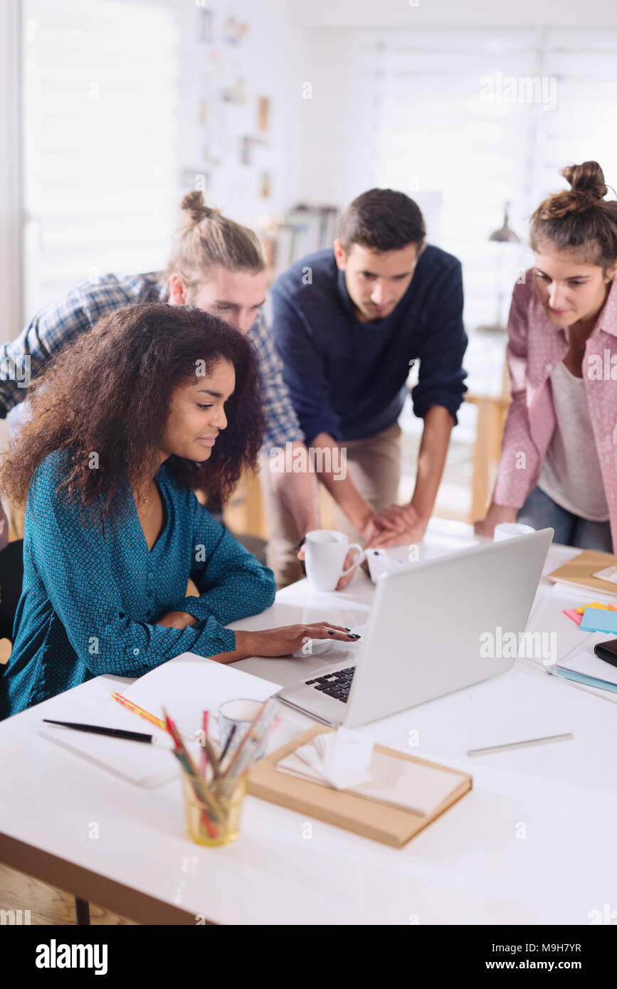 Young multiethnic creative team sharing ideas on a project  Stock Photo