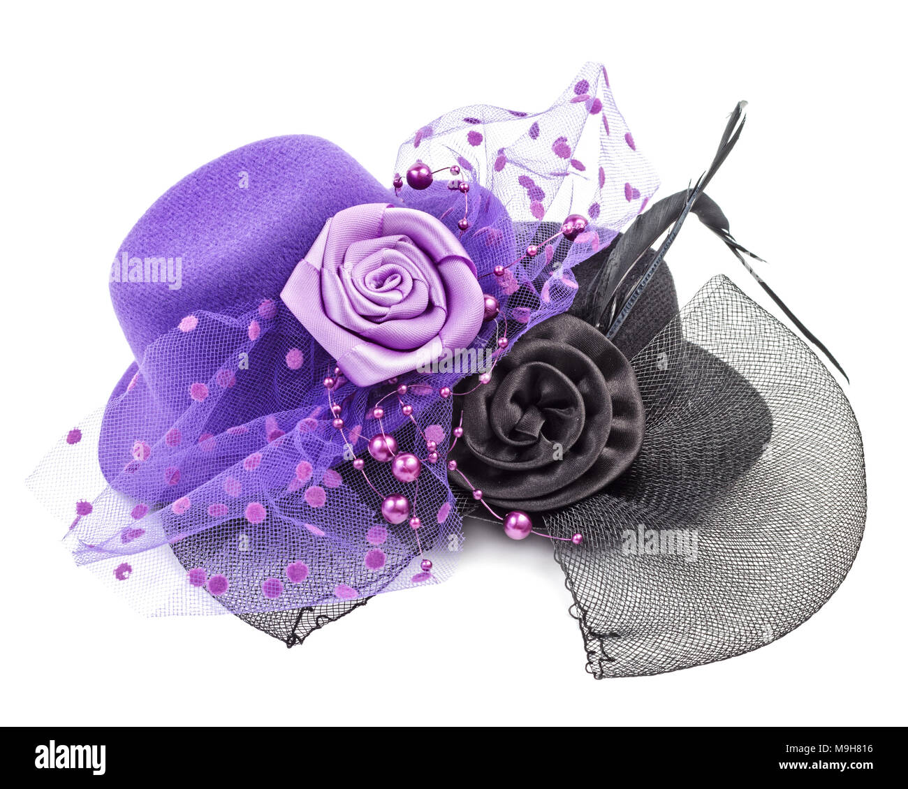 Purple and black antique ladies hats with flower isolated on white background Stock Photo