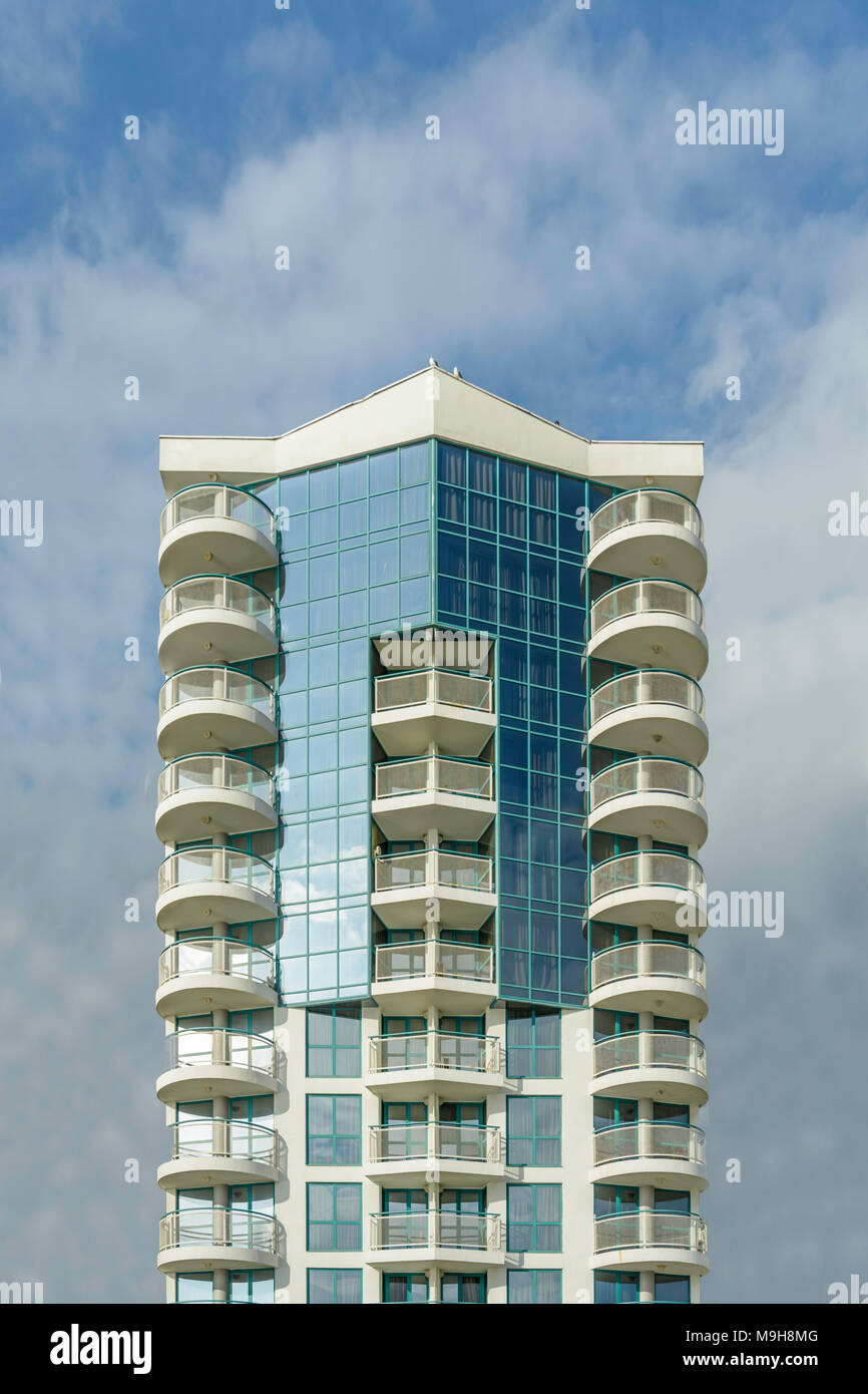 Modern building against vibrant blue sky with clouds Stock Photo - Alamy