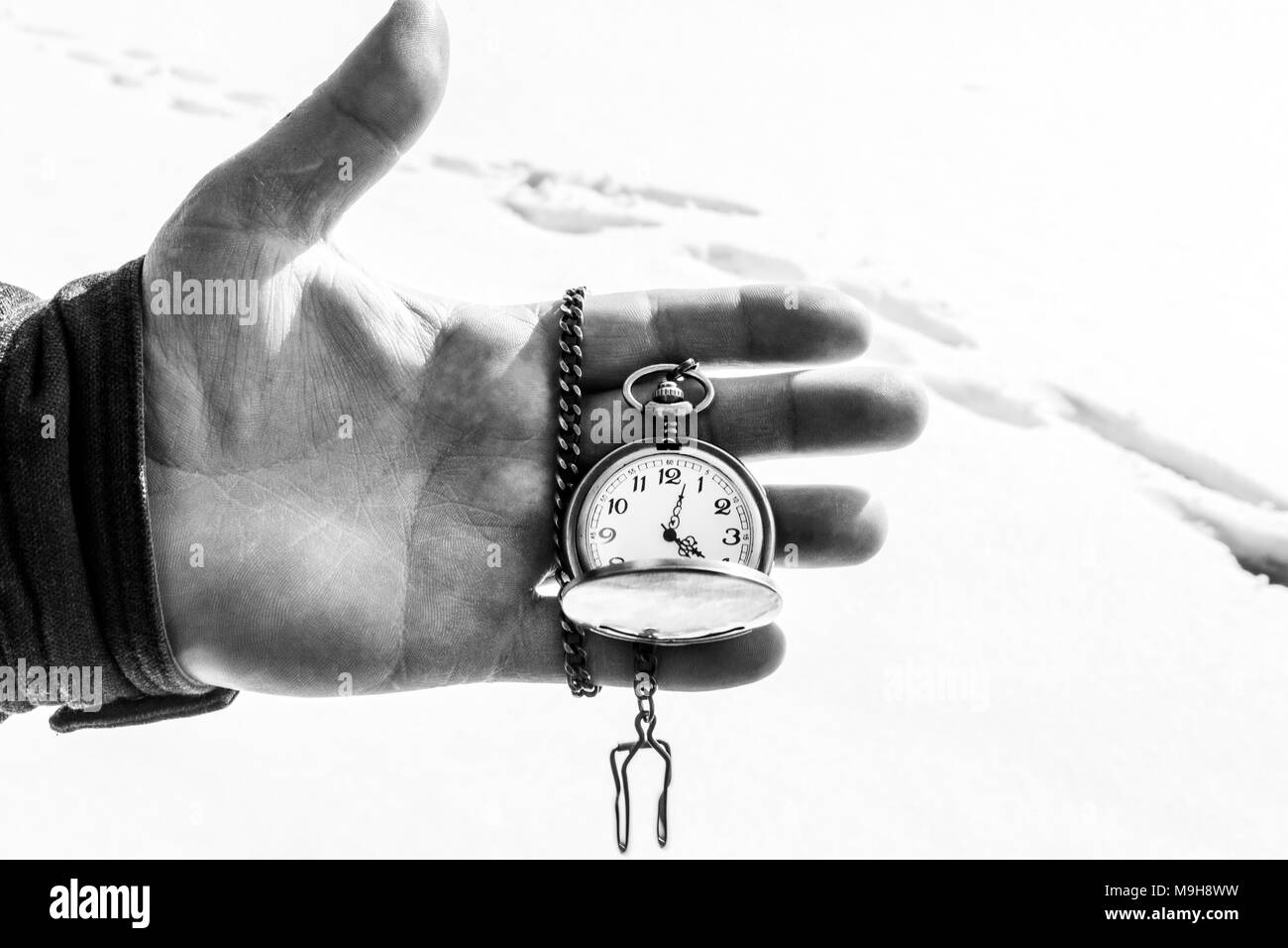 antique, old clock in hand blackandwhite photo, with space for text