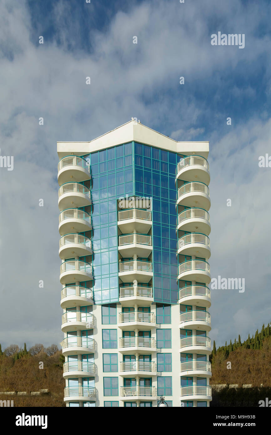 Modern building against vibrant blue sky with clouds Stock Photo - Alamy