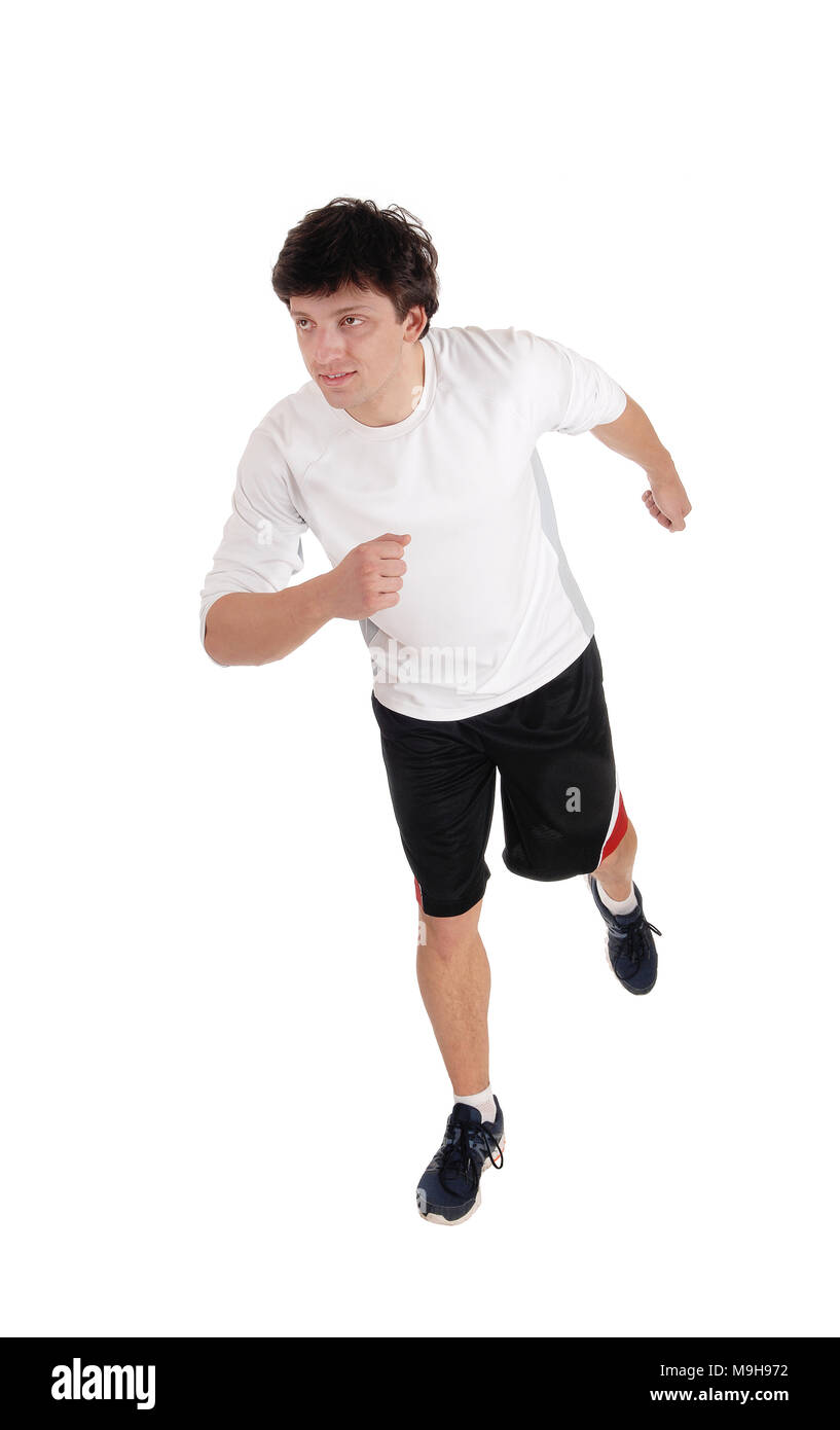 An handsome young man running in the studio in exercise outfit and running shoes, isolated for white background Stock Photo
