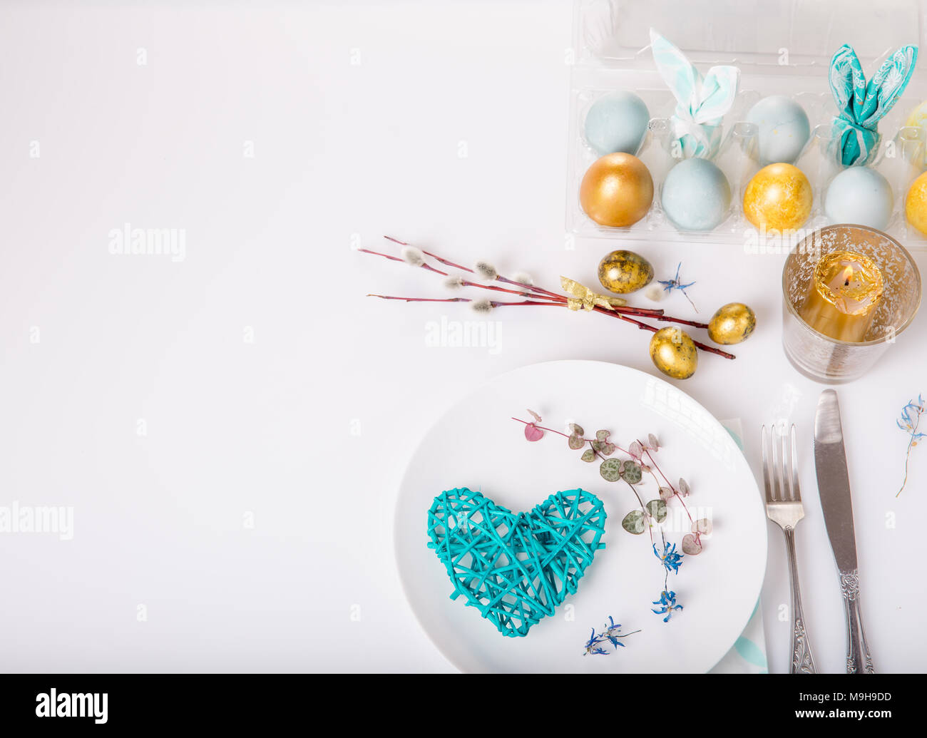 Easter table setting with gold and blue eggs and cutlery. Holidays background Stock Photo