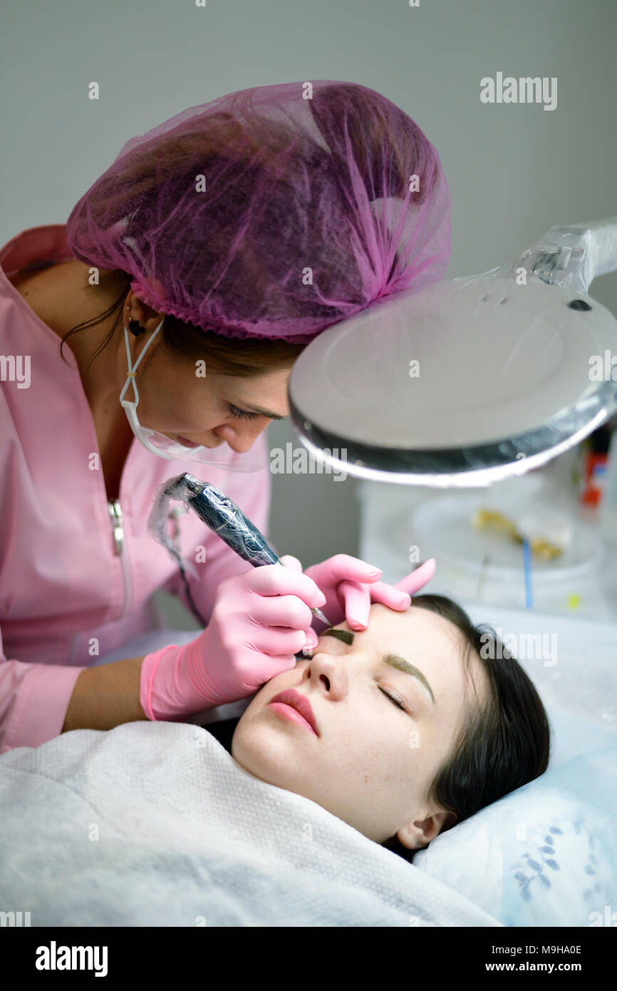 Master of permanent tattoo at work Stock Photo