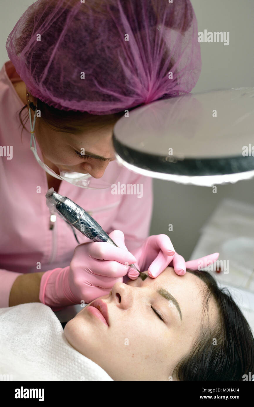 Master of permanent machine tattoo from work Stock Photo