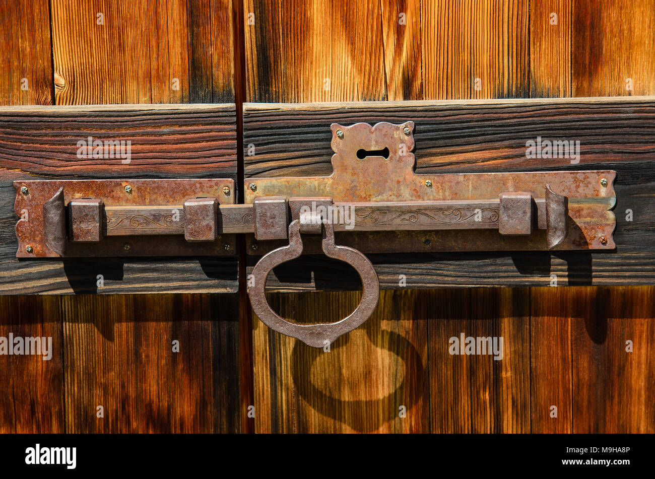 old latch on wooden door with keyhole Stock Photo