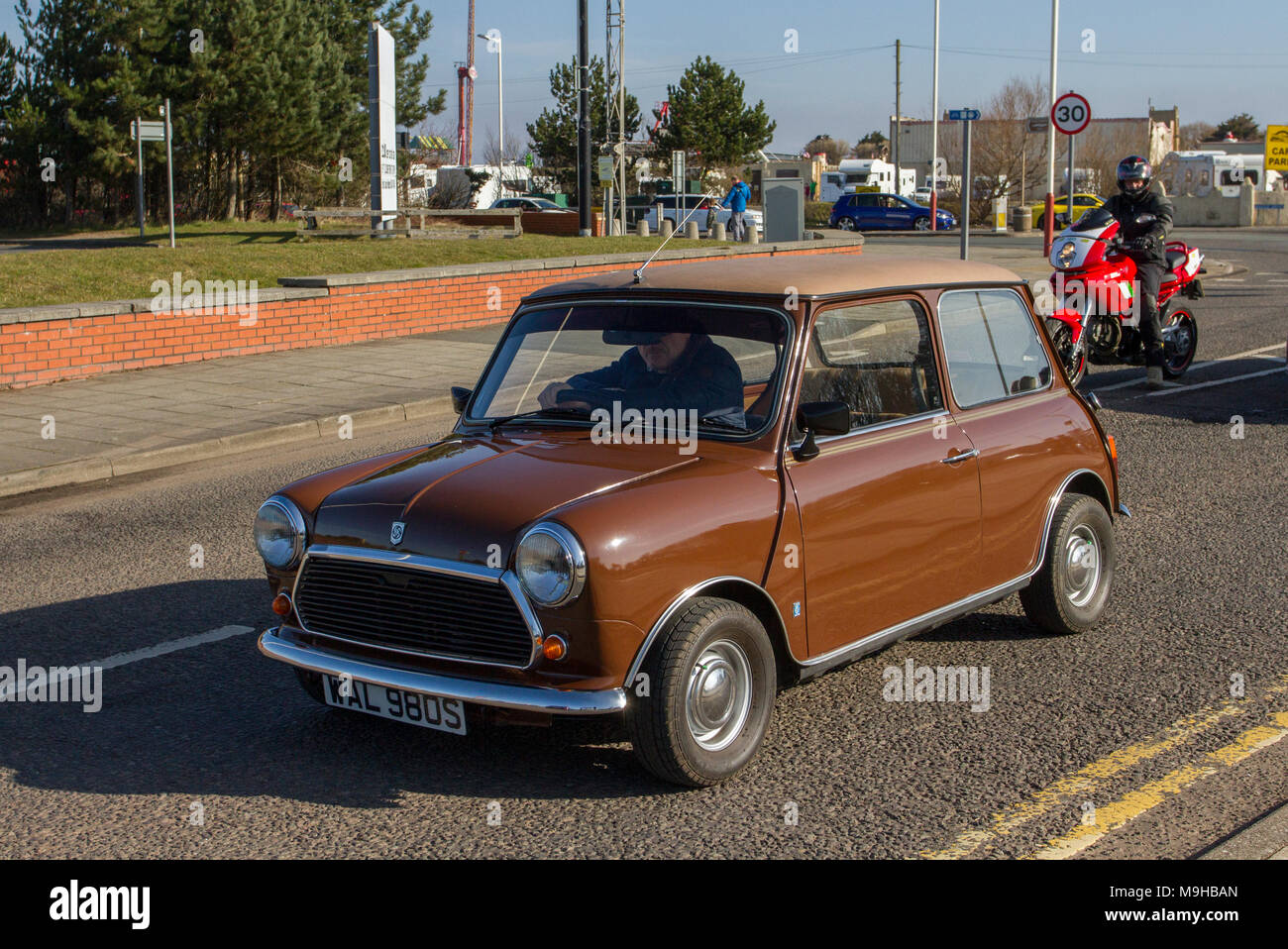 1978 70s brown Leyland mini 1000 at then North-West Supercar event as  1970s cars and tourists arrive in the coastal resort of Southport, on a warm spring day. SuperCars are bumper to bumper on the seafront esplanade as classic & 70s vintage car enthusiasts enjoy a motoring day out. Stock Photo