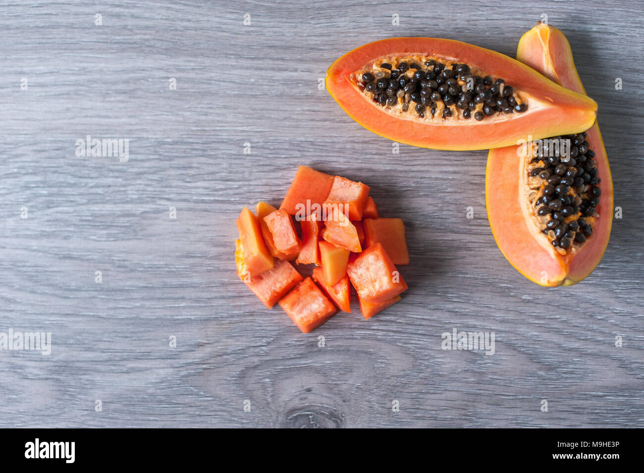 Papaya Fruit Cut In Slices On Wooden Background Stock Photo Alamy Papaya Fruit Cut In Slices On Wooden Background Stock Photo Alamy