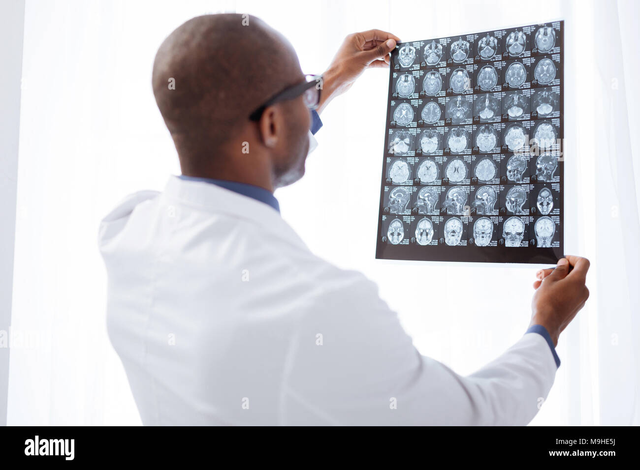 Appealing male doctor evaluating brain imaging Stock Photo
