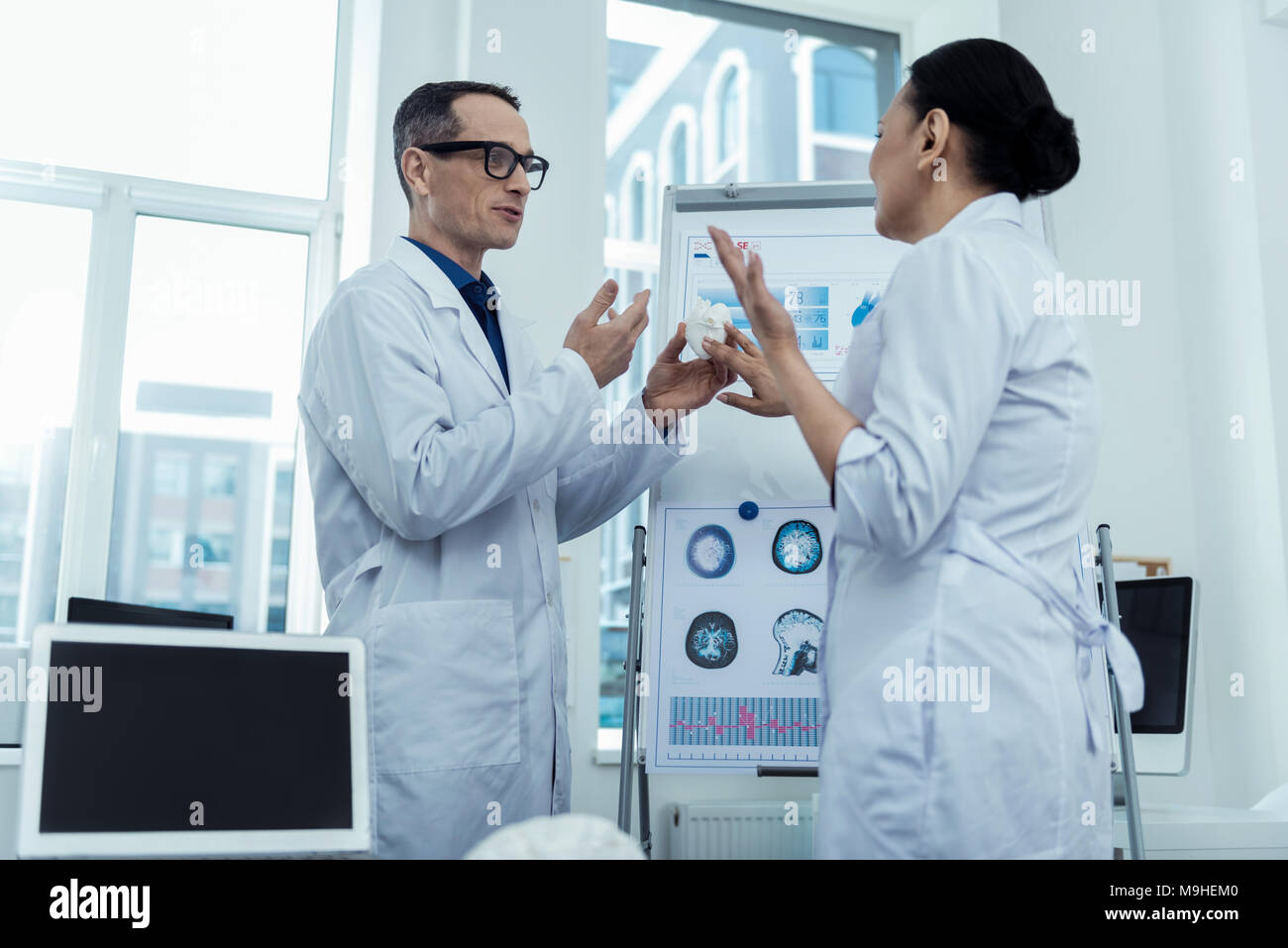 Professional doctors holding a model of heart Stock Photo - Alamy
