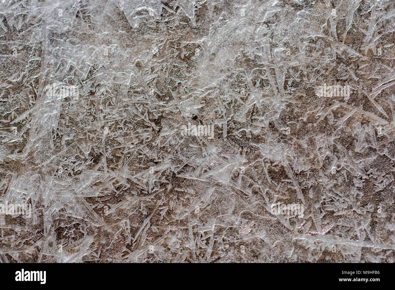 Texture of frozen ice, under which there is sand Stock Photo - Alamy