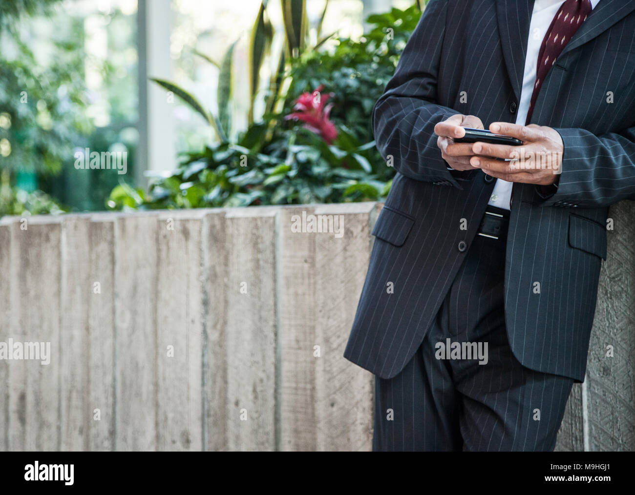 Close-up of a business man texing on a cell phone. Stock Photo