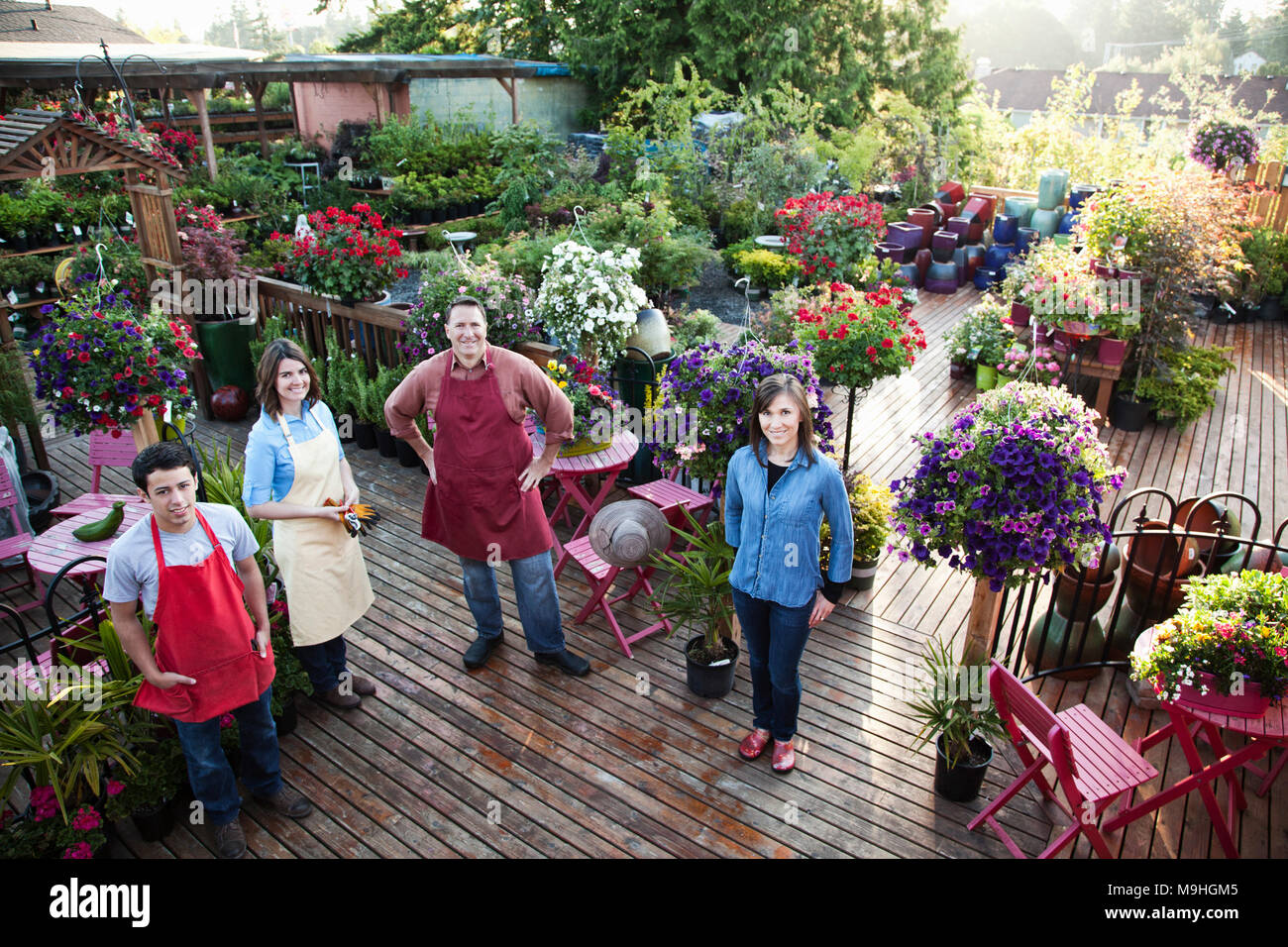 Nursery store owners and employees standing next to plants Stock Photo Alamy