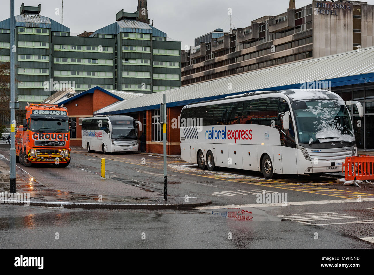 National Express coaches and heavy haulage tow truck at Pool Meadow Bus Station, Fairfax Street, Coventry, West Midlands, UK. Stock Photo
