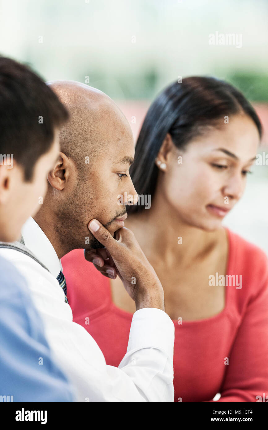 Mixed race team of business people at a table in a business center ...