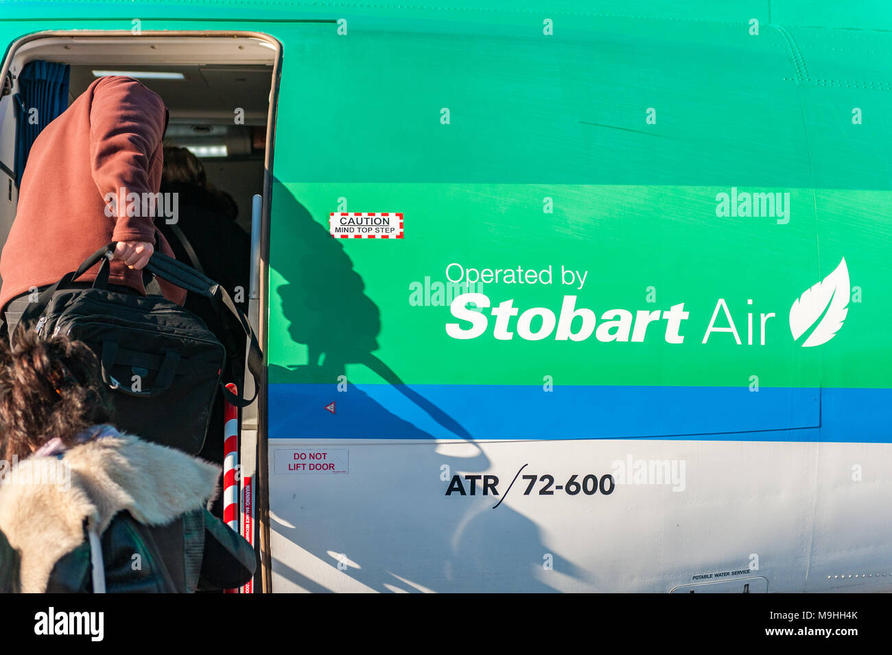 Passengers board an Aer Lingus/Stobart Air ATR 72-600 aircraft at Birmingham Airport heading to Cork, Ireland with copy space. Stock Photo
