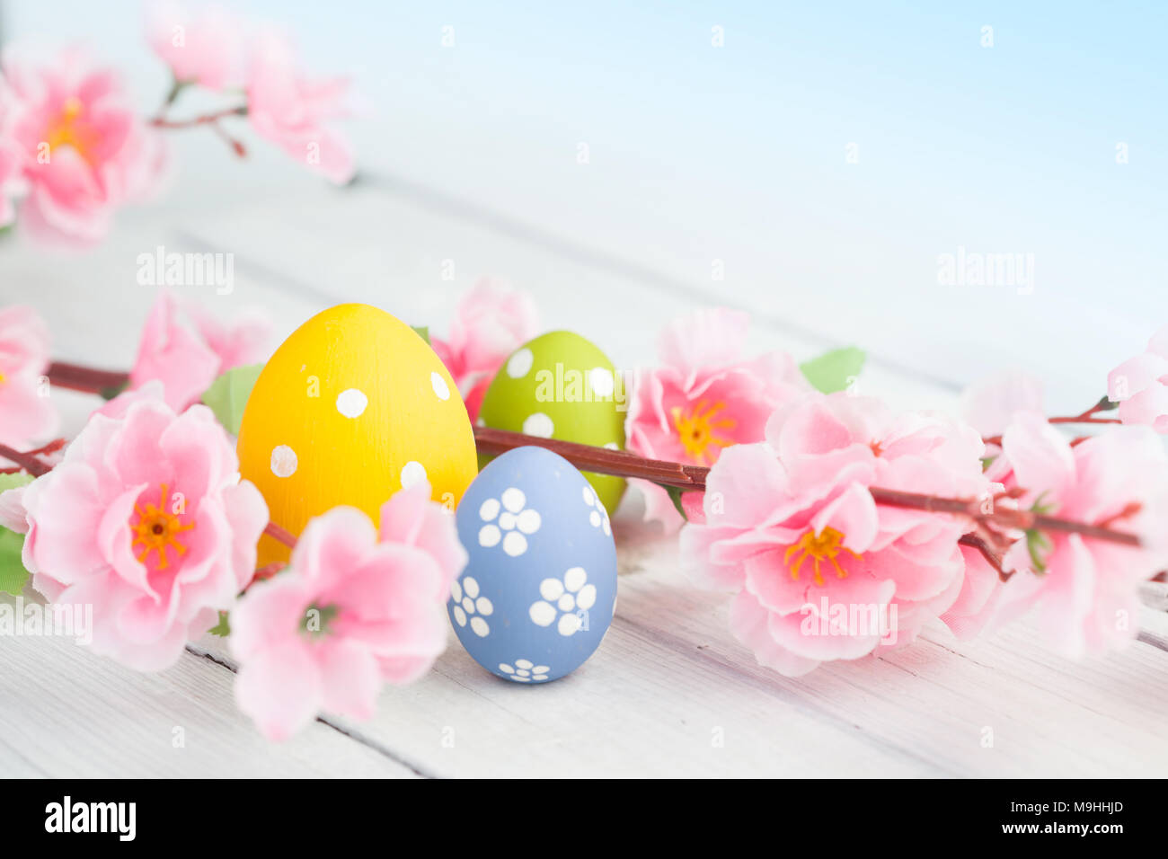 Spring flowers and colorful easter eggs Stock Photo