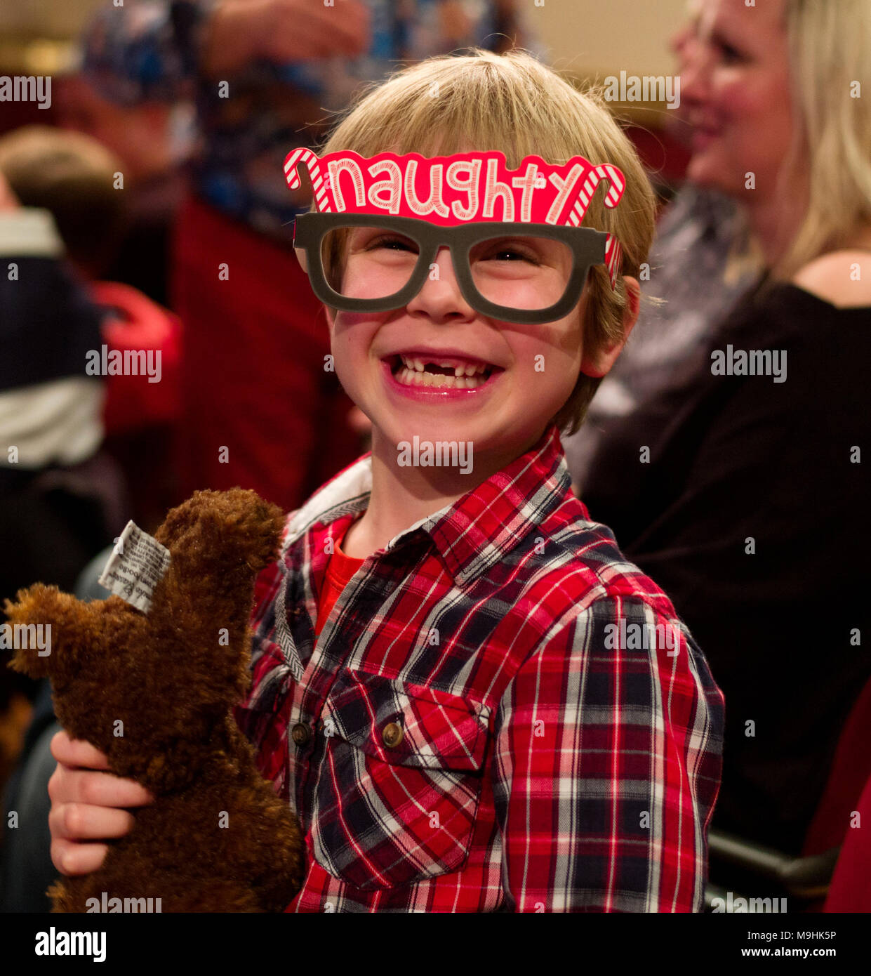 Ralph aged 6, model released, wearing his 'Naughty' glasses at a Christmas Pantomime in Suffolk England UK. 26 Dec 2017 Stock Photo