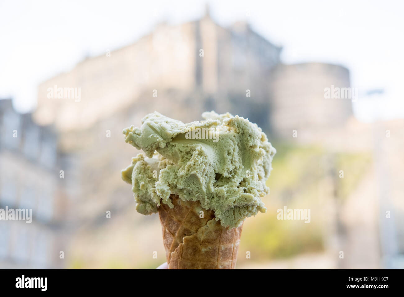 Hand holding pistachio Gelato, Icecream with blur background of