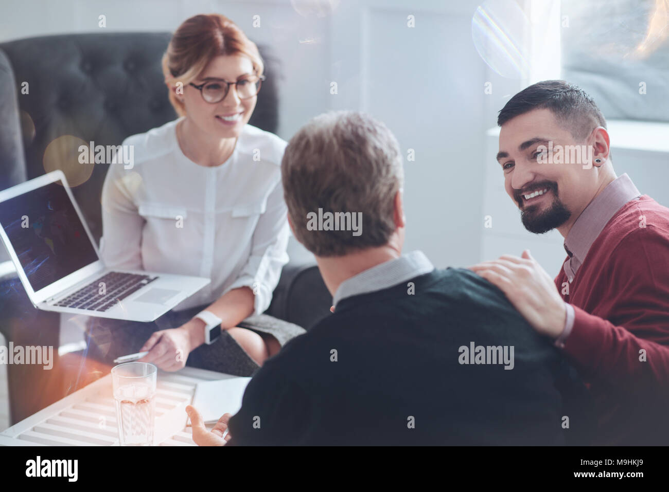 Happy bearded man looking at his colleague Stock Photo