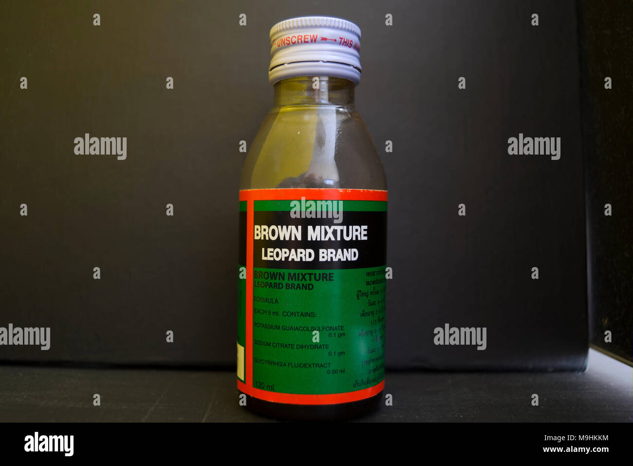 a bottle of brown mixture, an opium derivative thai medicine used to treat coughs Stock Photo