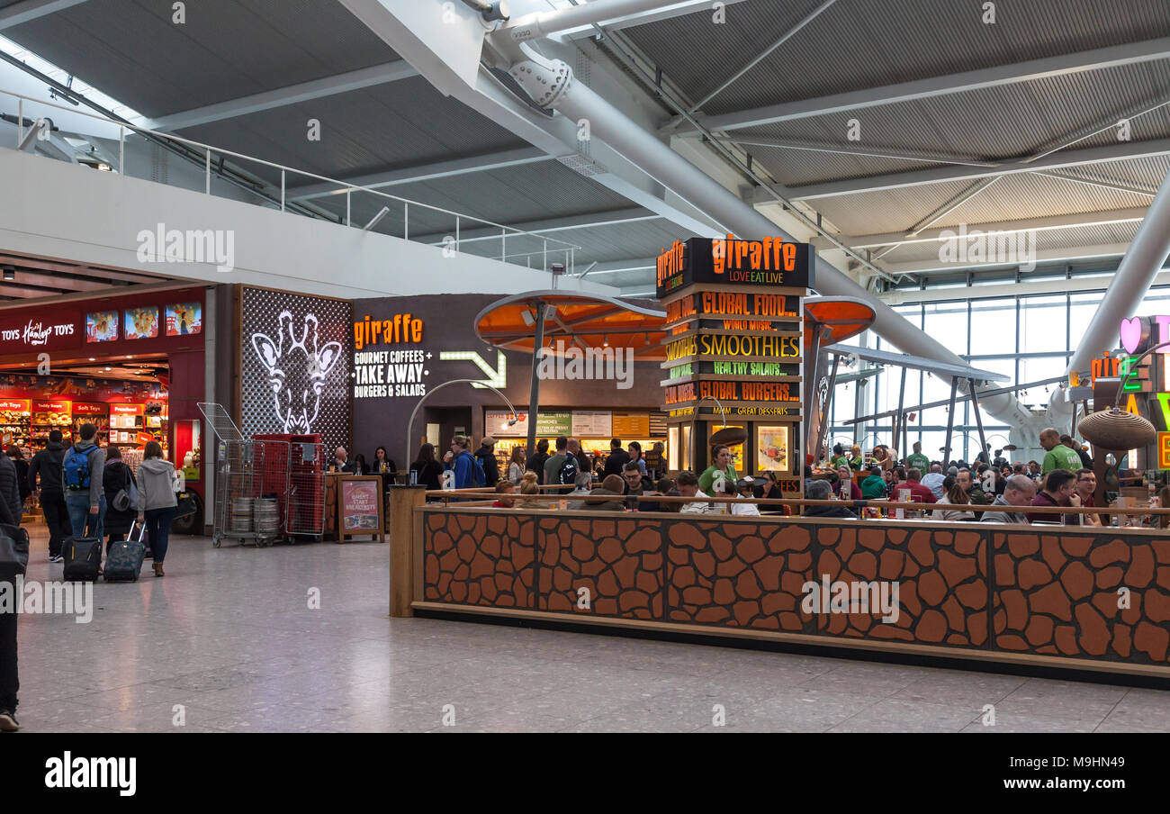 The Giraffe cafe and take away outlet at Heathrow Airport Terminal Five Departures area. Hamleys Toys retail unit is on the left of the image. Passeng Stock Photo