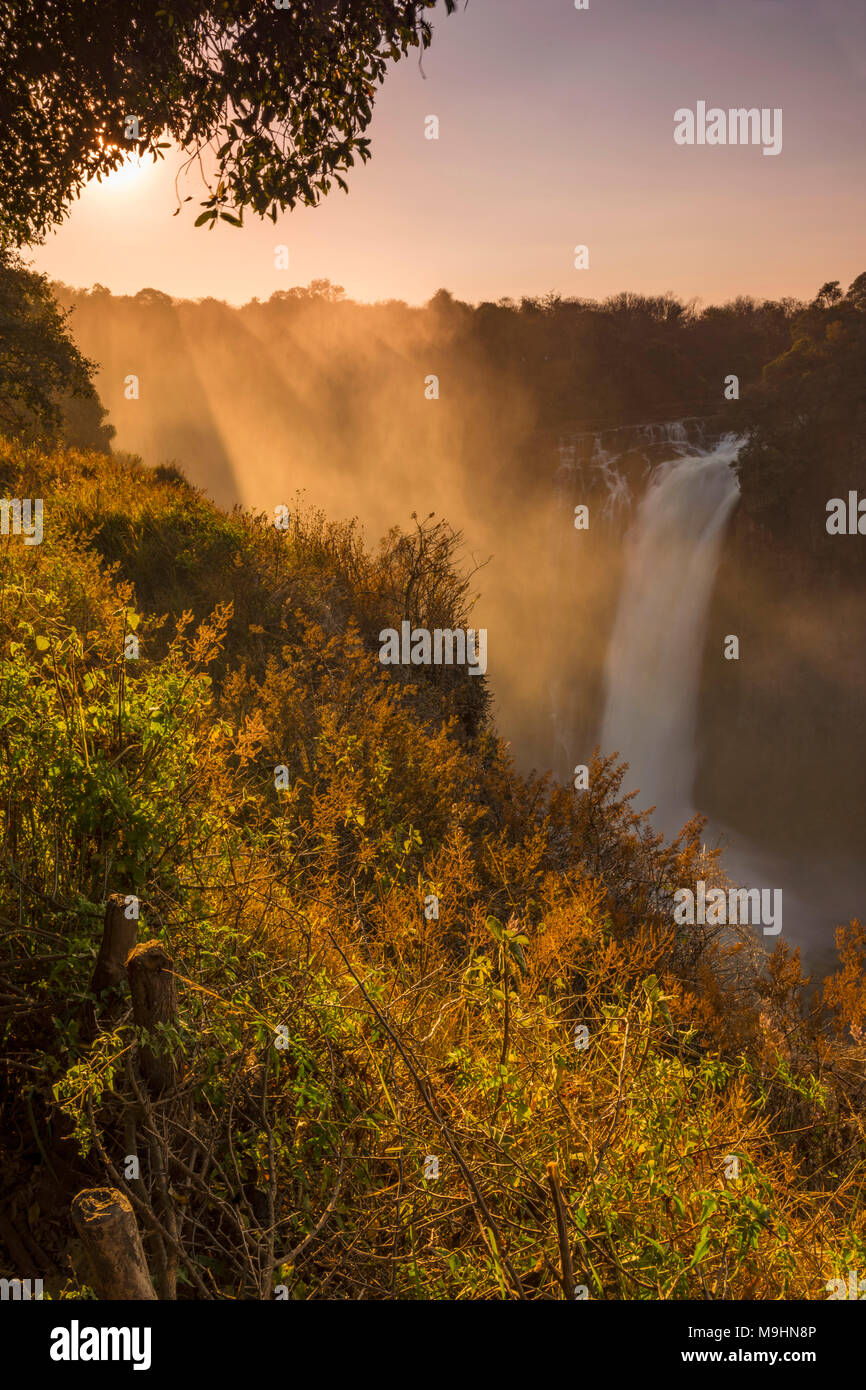 The sun rises over Devils Cataract, Victoria Falls Zimbabwe. Stock Photo