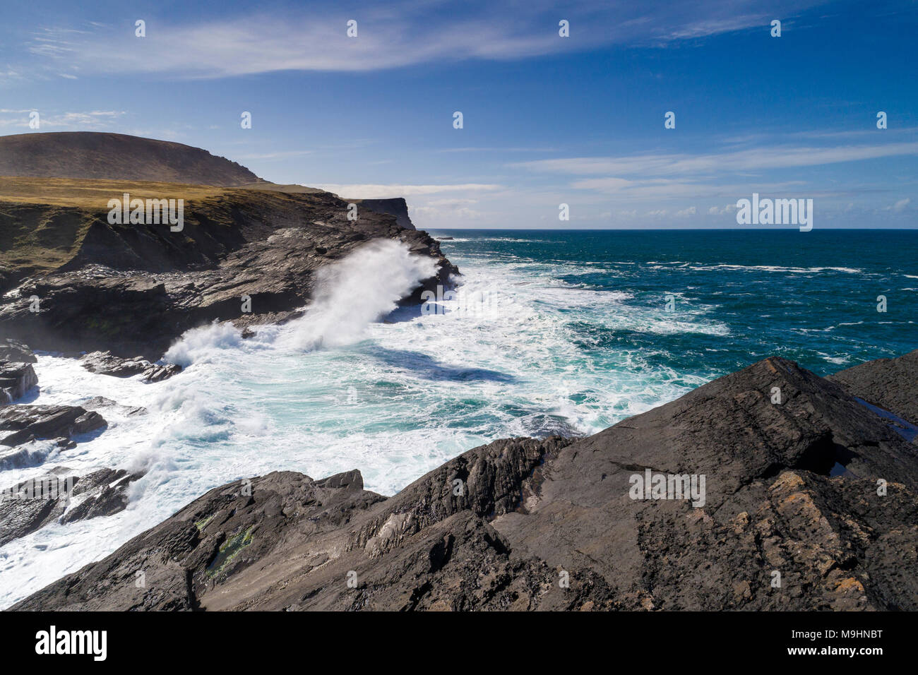 Waves crashing against cliffs on north side of Valentia Island, County Kerry, Ireland Stock Photo