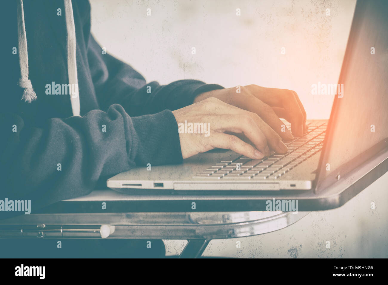 Hacker using laptop stealing data,concept for network security and cyber attack. Stock Photo