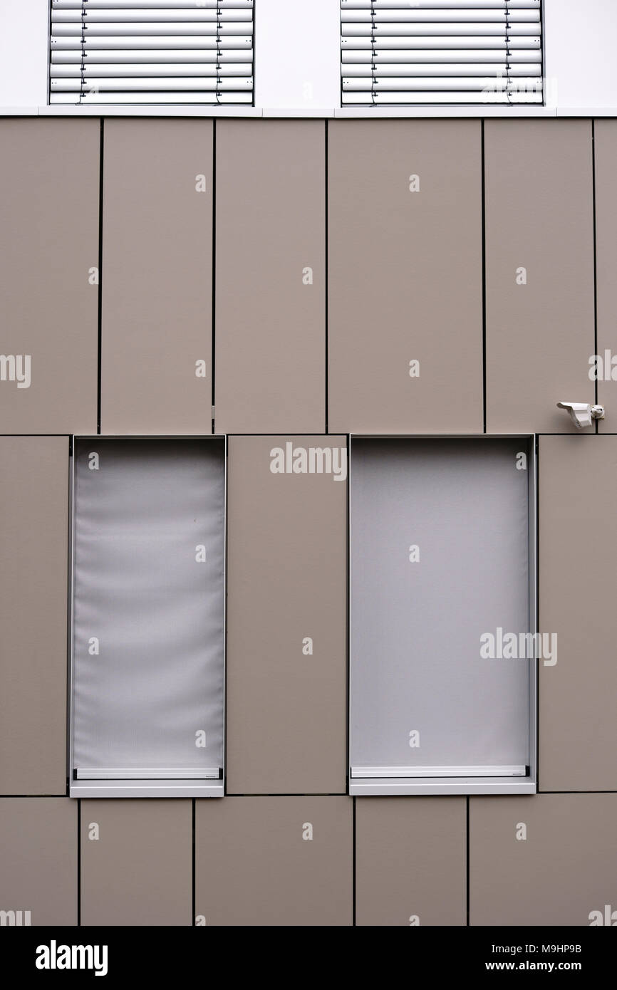 A modern office building facade with sheet metal covering and an ...