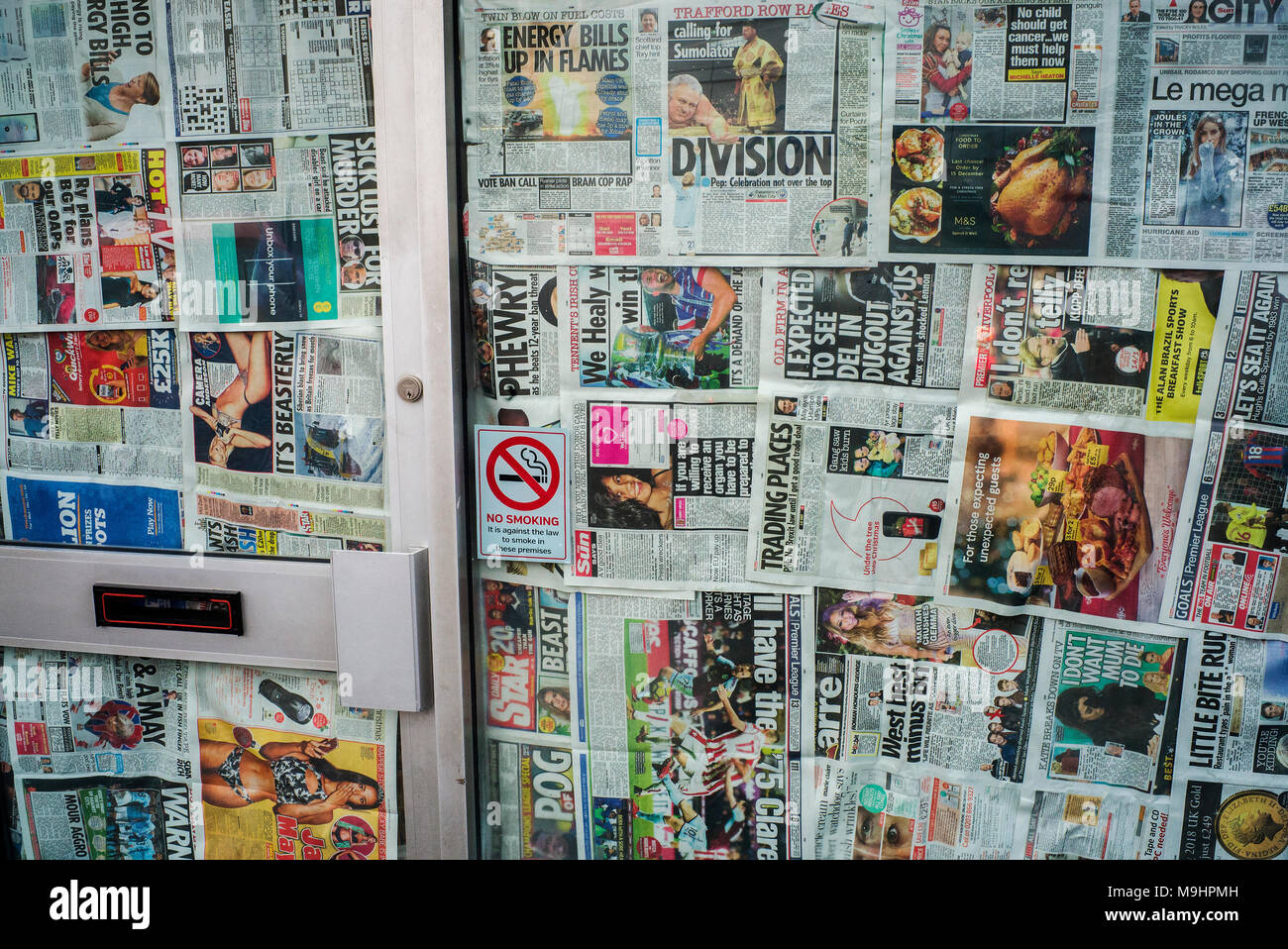newspapers pages used to cover windows of deserted shop Stock Photo