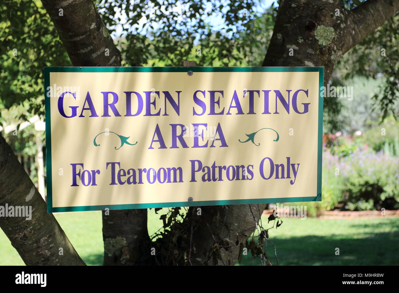 Garden Seating Area signboard under the tree Stock Photo