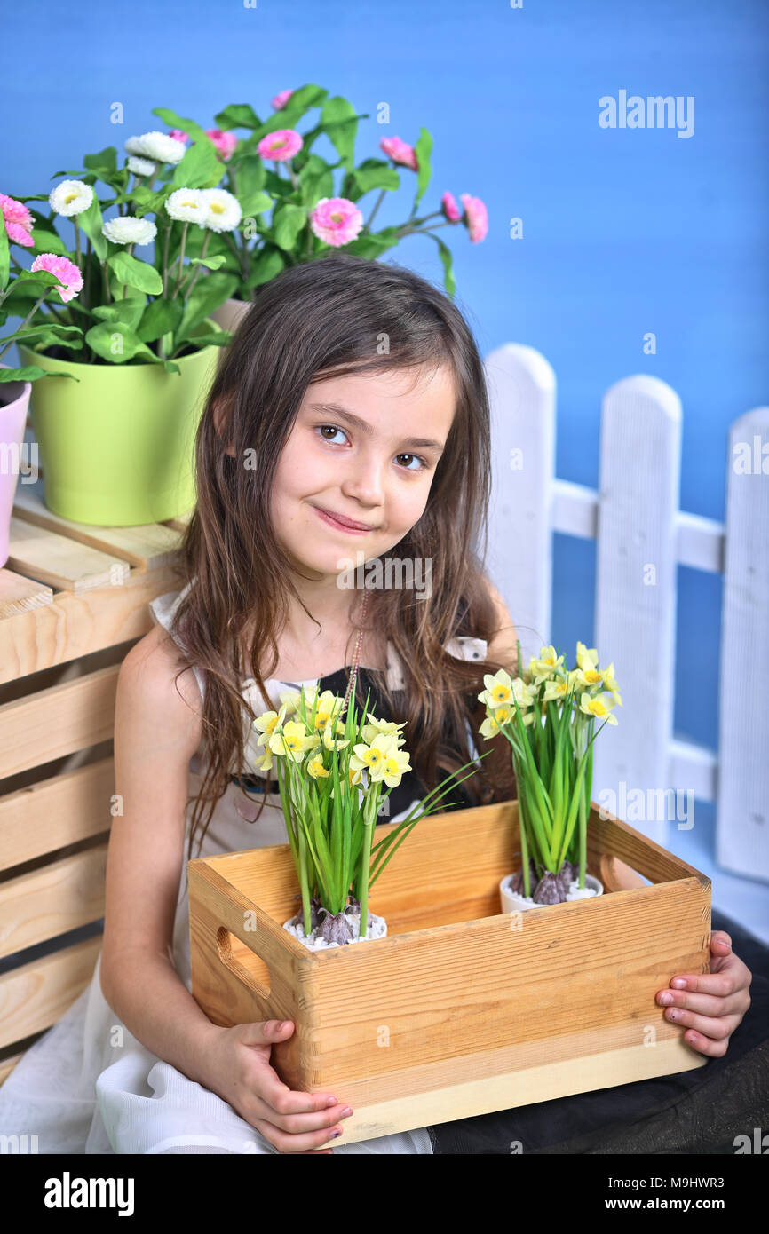 young and smiling girl is holding a flower pot Stock Photo - Alamy