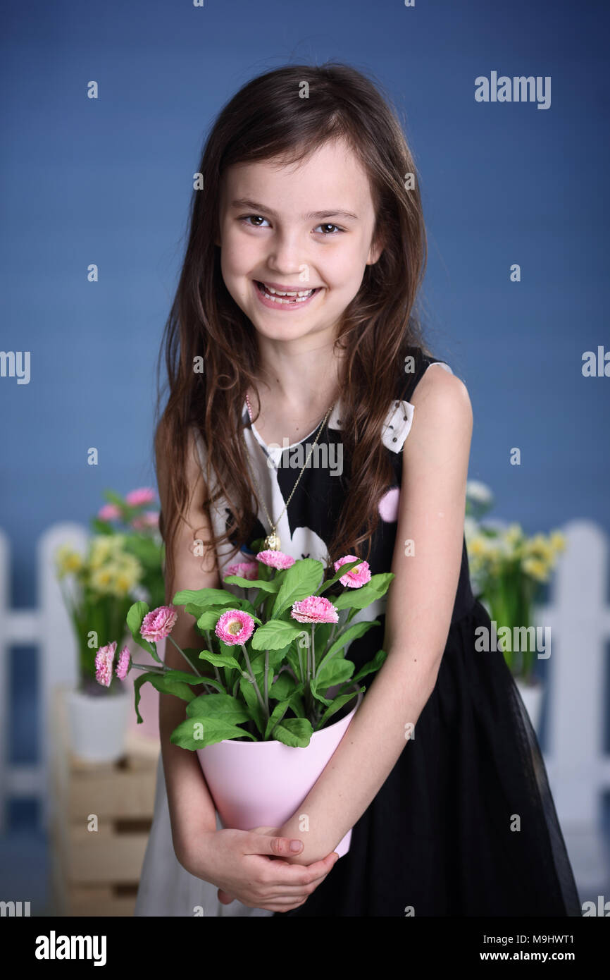 Girl holding a flower hi-res stock photography and images - Alamy