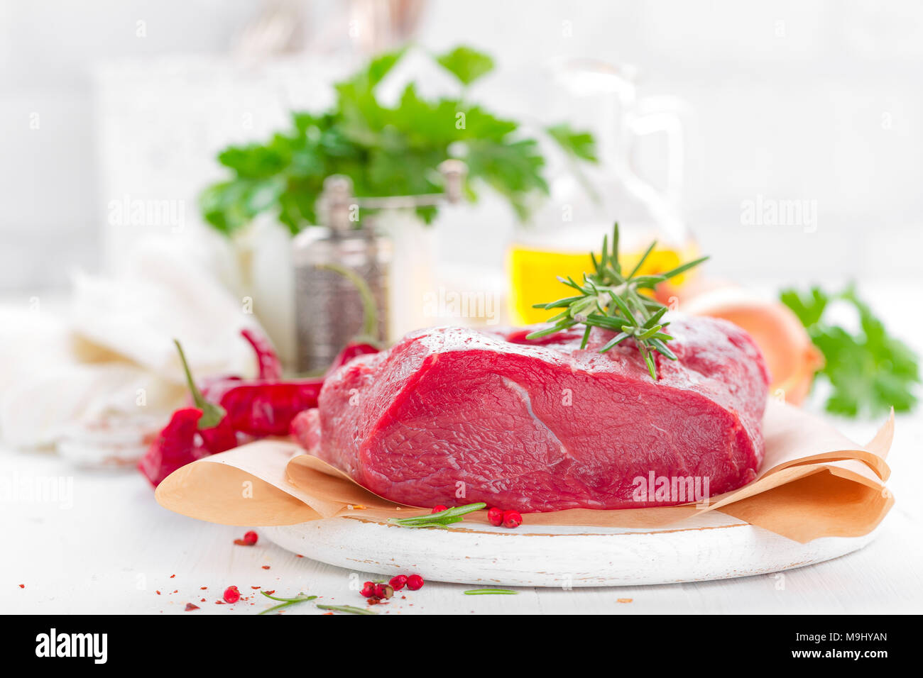 Raw beef meat tenderloin on white background with cooking ingredients ...