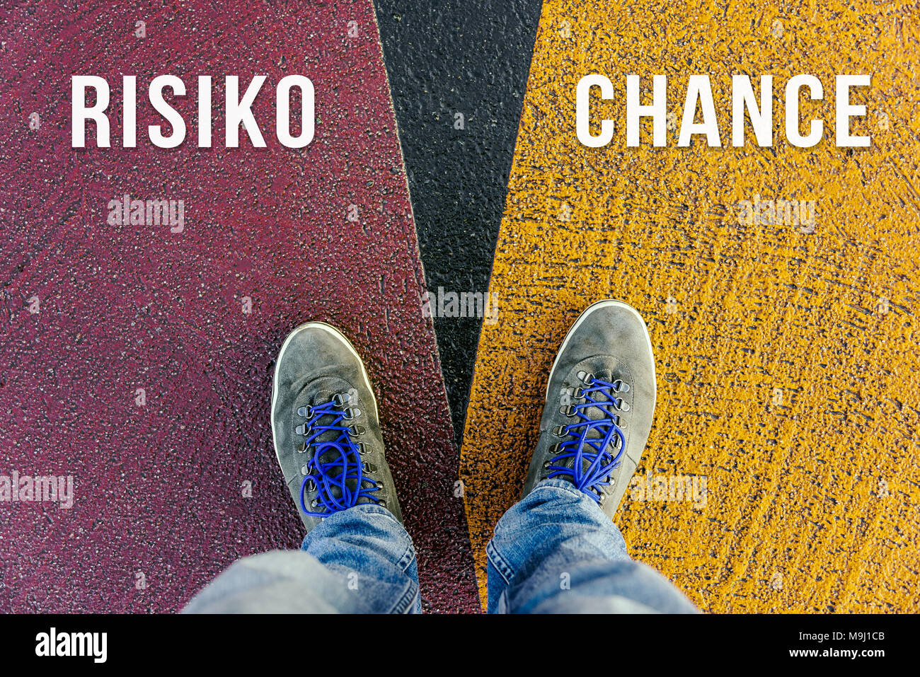 Reaching a crossroads having to choose between risiko and chance meaning risk and chance symbolized by two feet standing on two different colors with  Stock Photo