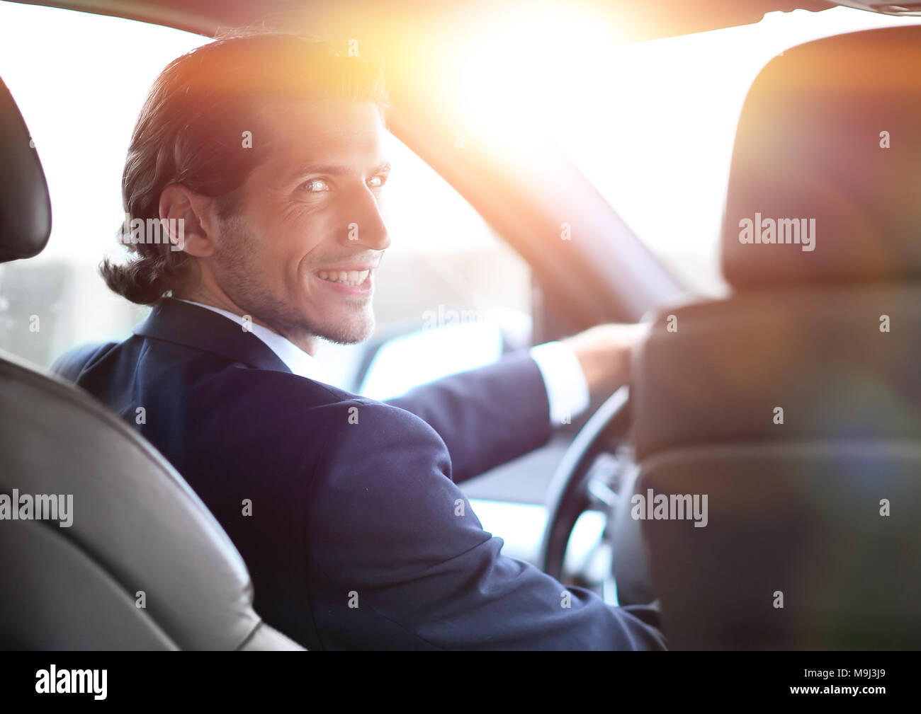 man sitting behind the wheel of a car Stock Photo - Alamy