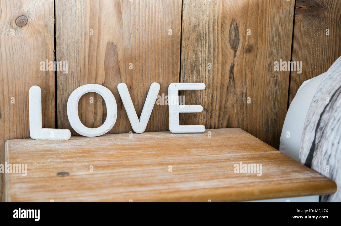 wooden love letters on bedside table Stock Photo