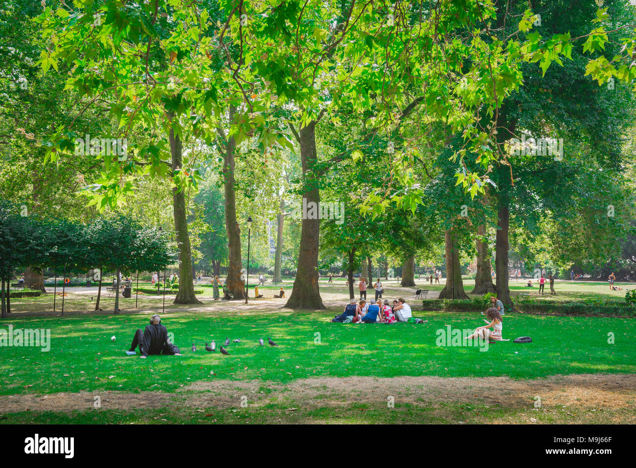 Russell Square London, on a summer morning people relax in Russell Square in the Bloomsbury area of London, UK. Stock Photo