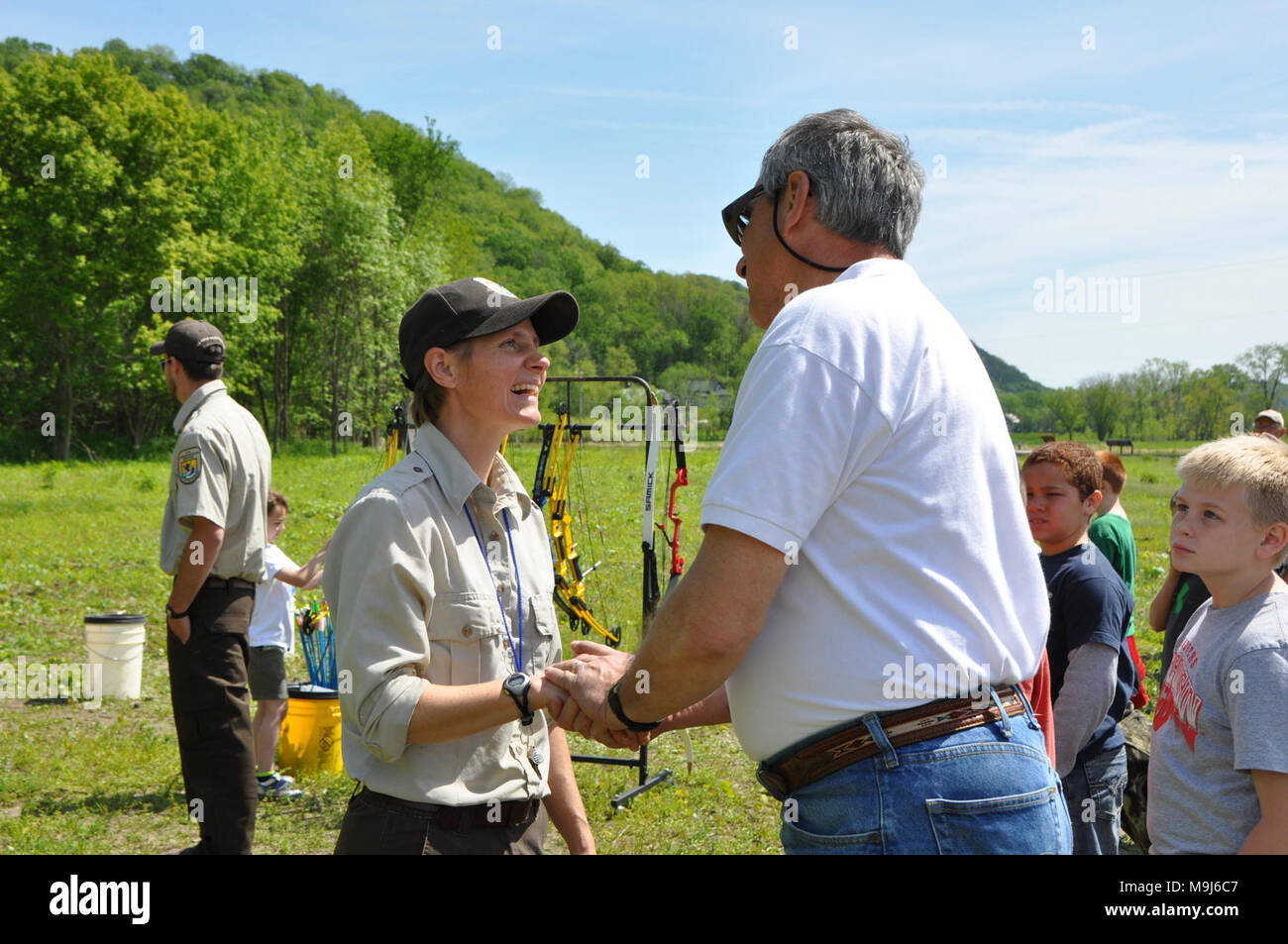 Midwest Regional Director, Tom Melius, congratulates Genoa NFH staff member, Jen Bailey, on Genoa's new archery outreach program for children. Stock Photo