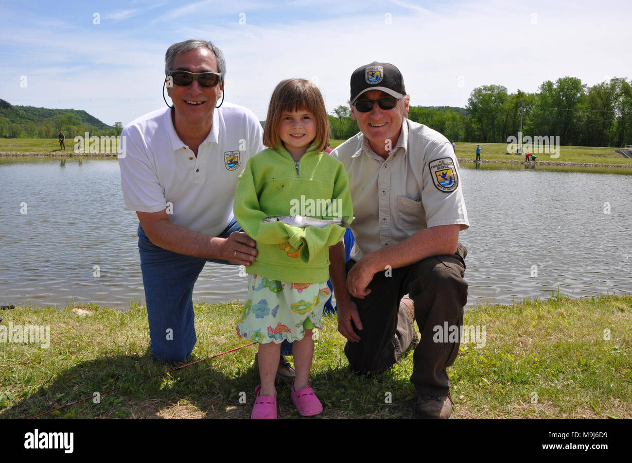 Midwest Regional Director Tom Melius Left And Genoa National Fish Hatchery Manager Right Doug Aloisi Pictured With One Of The Many Young Fishers Who Enjoyed Kid S Fishing Day Hosted By Genoa Nfh Stock