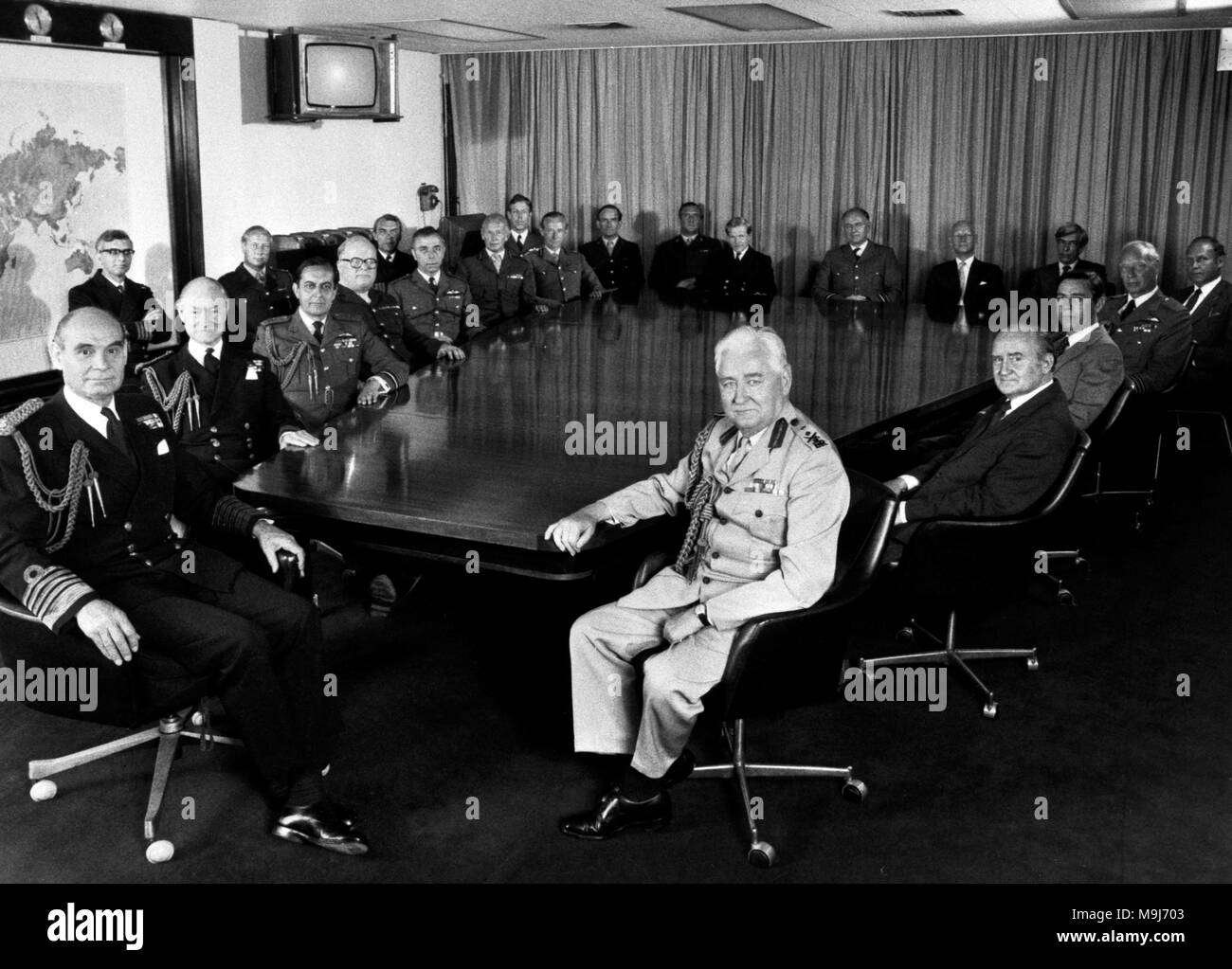 The Chiefs of Defence Staff grouped around the conference table in Whitehall at the height of the Falklands conflict. (L-R) Admiral of The Fleet Sir Terence Lewin, Chief of Defence Staff; Captain Raymond, Deputy Secretary, Chief of Staff's Committee; Admiral Sir Henry Leach, Chief of the Naval Staff and First Sea Lord; Lieutenant Colonel Bale, Assistant Secretary One; Air Chief Marshal Sir Michael Beetham, Chief of the Air Staff; Brigadier Eyre, Secretary, Chief of Staff's Committee; Commander Bickley, Assistant Secretary Two; Air Vice Marshal Gilbert, Assistant Chief of the Defence Staff (pol Stock Photo