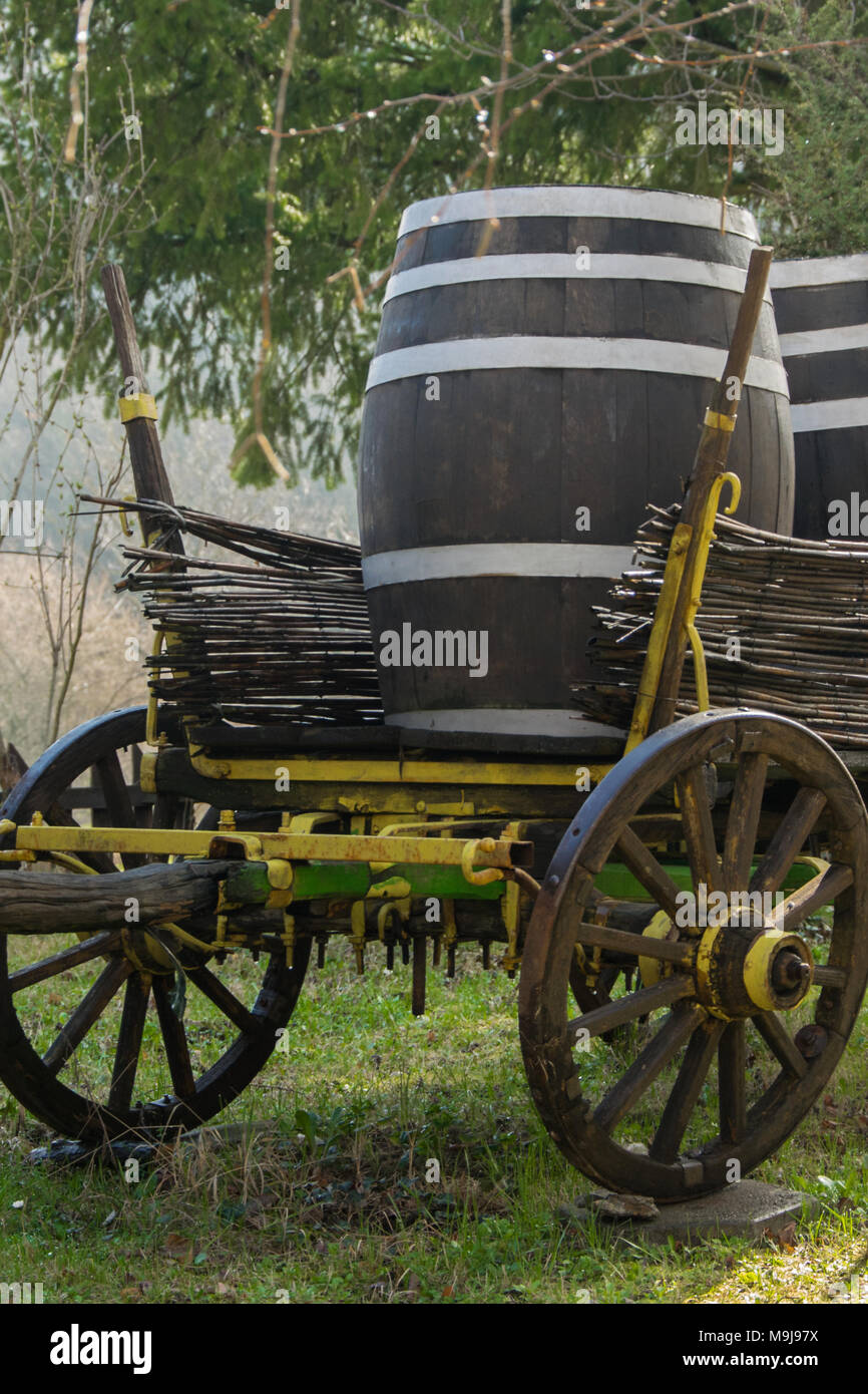 Antique cart for transporting goods with two wine or beer barrels on