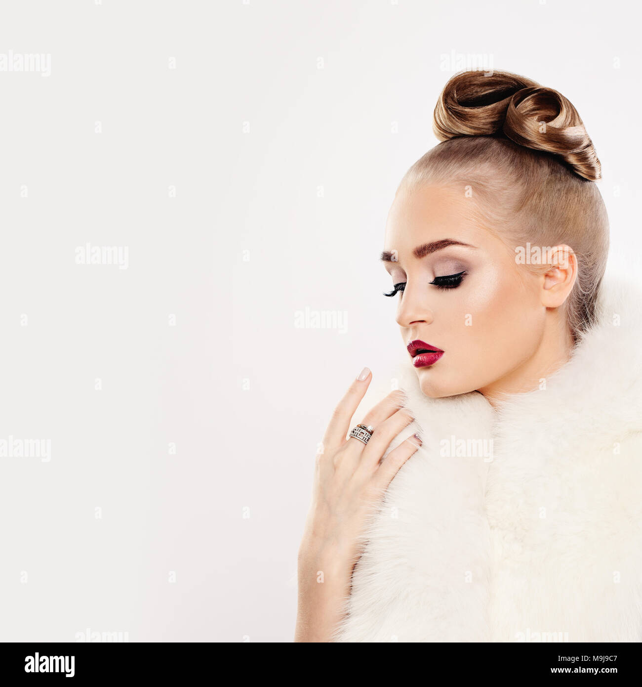 Fashion Woman in White Fur and Diamonds Ring Stock Photo