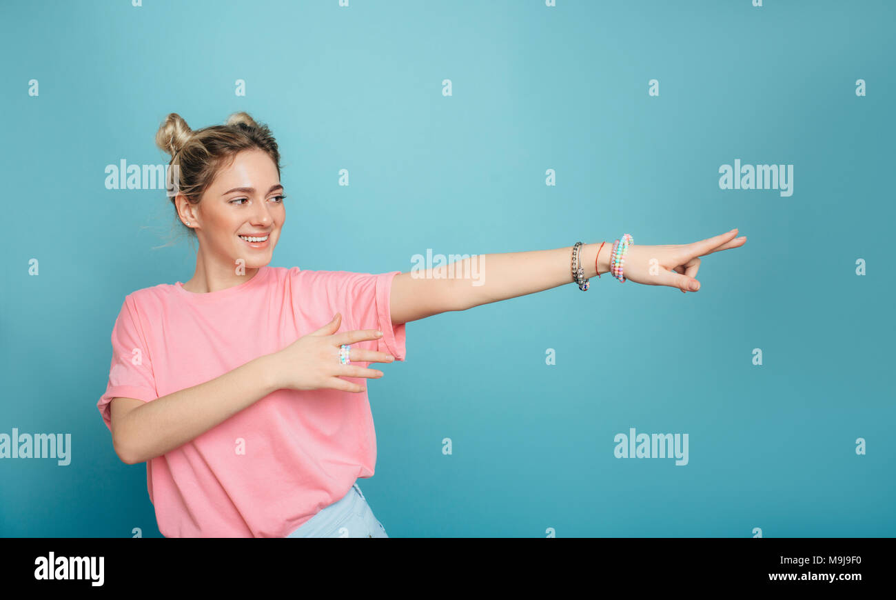 modern young woman pointing copy space and smiling Stock Photo