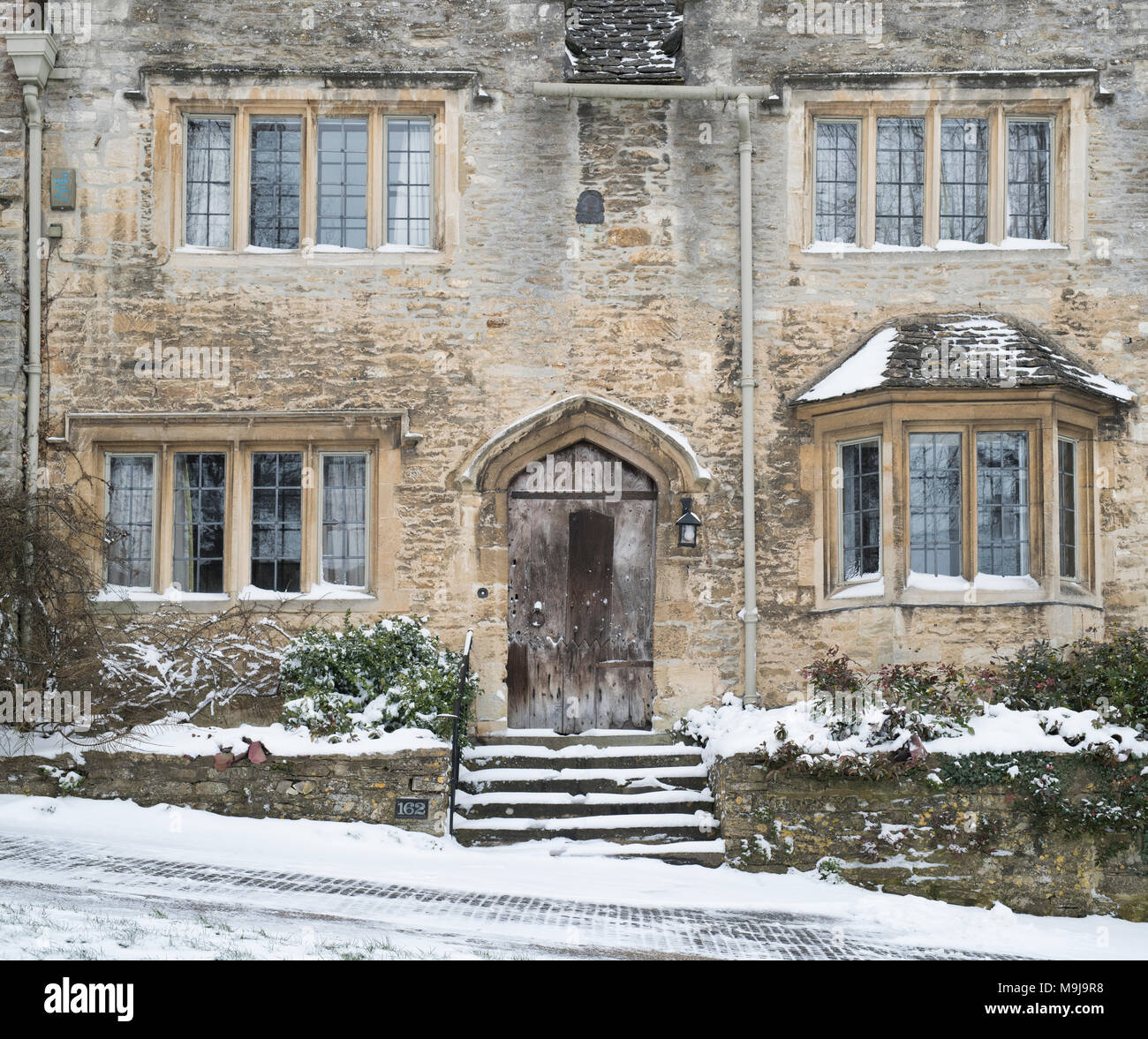 Burford stone house on the hill in Burford in the winter snow. Burford