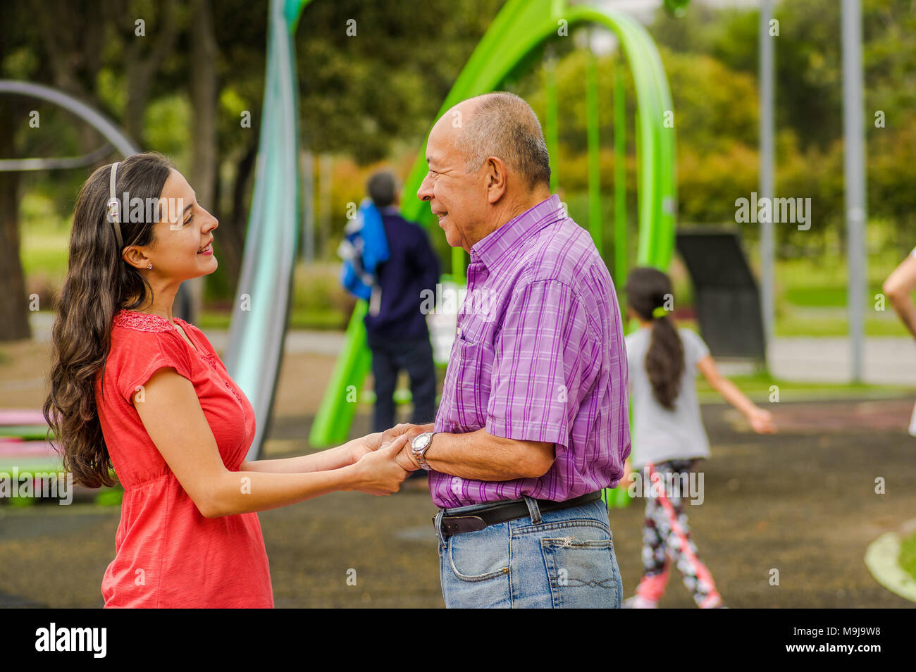 Outdoor view of daughter and father holding their hands at outdoors in ...